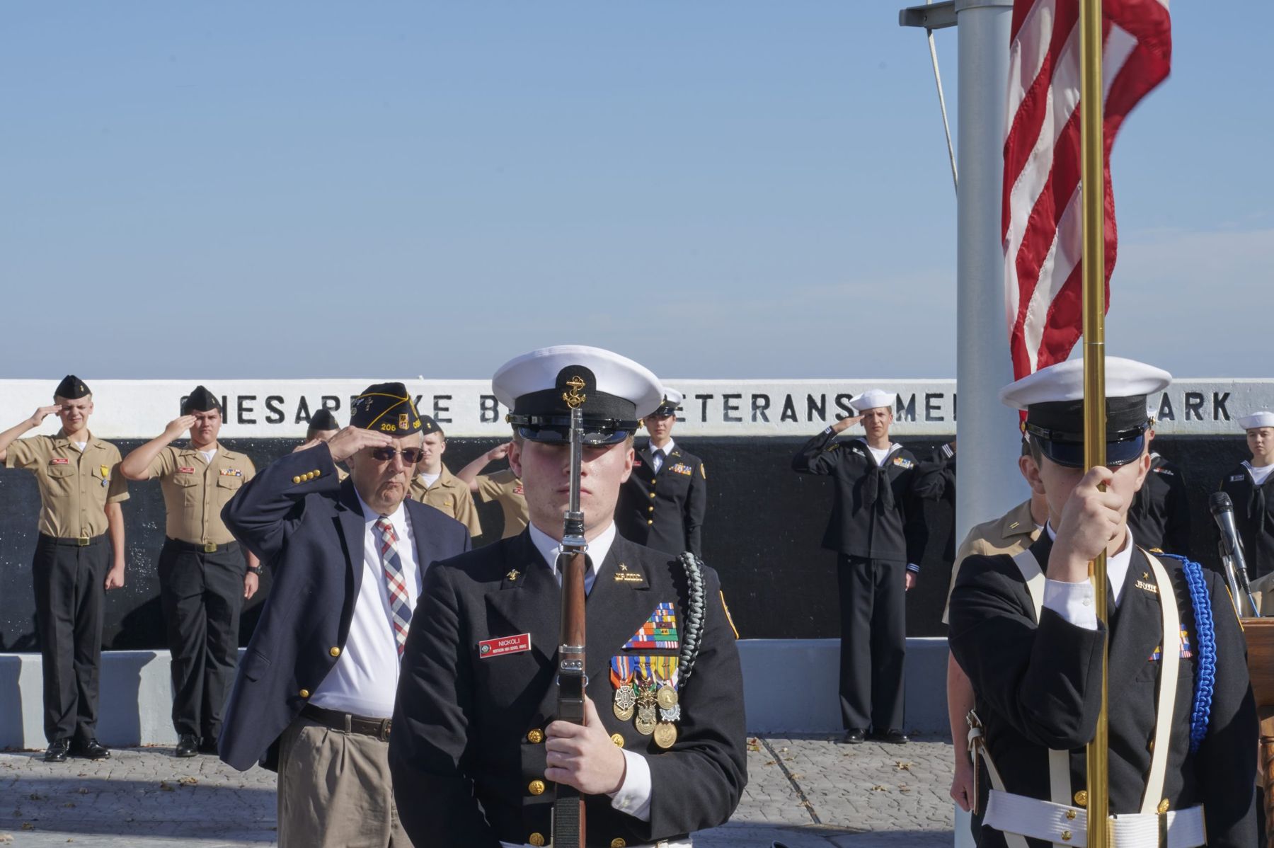 Color guard and veterans saluting at Chesapeake Beach Veterans Memorial Park