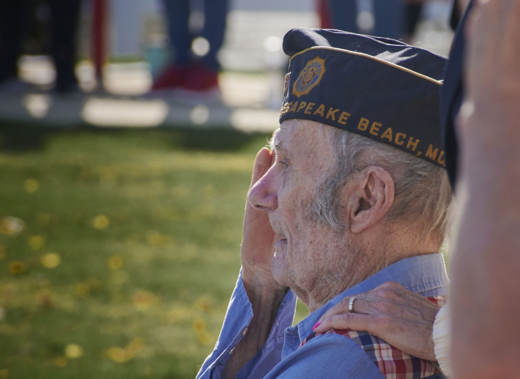 Elderly veteran in a Post 206 cap saluting